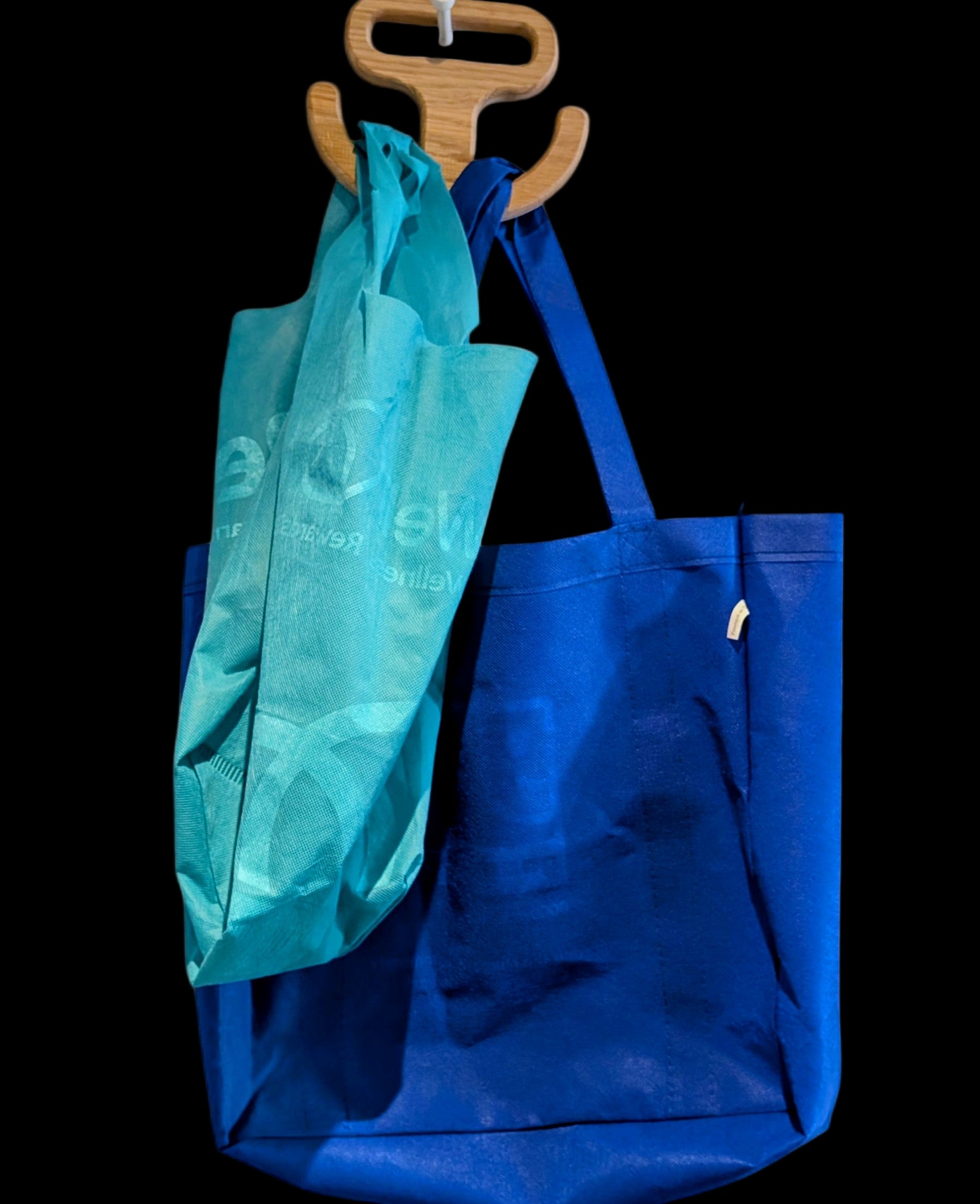 Solid hardwood grocery bag carry handle shaped like an anchor, with a smooth ergonomic grip and rectangular cutout for easy carrying of heavy shopping bags.