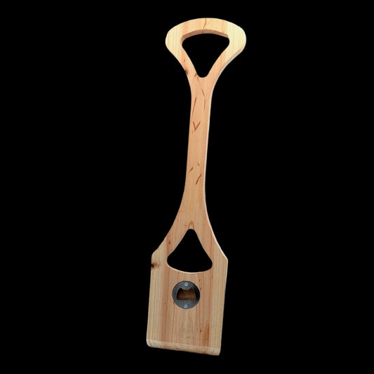 Close-up of cedar BBQ scraper tool with ergonomic grip and metal bottle opener